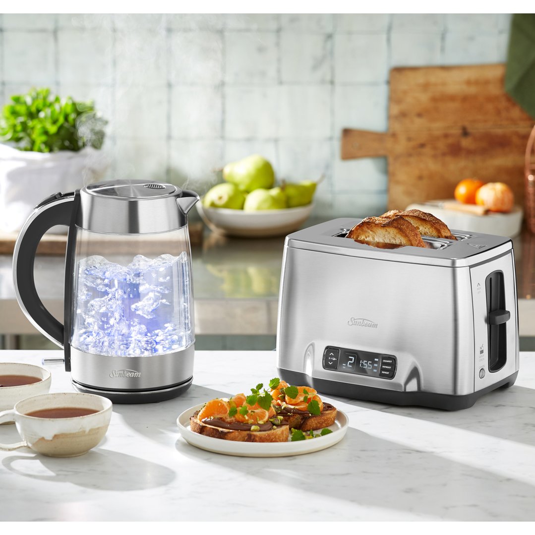 Sunbeam Maestro Dual Wall Glass Kettle and toaster on a kitchen counter with food