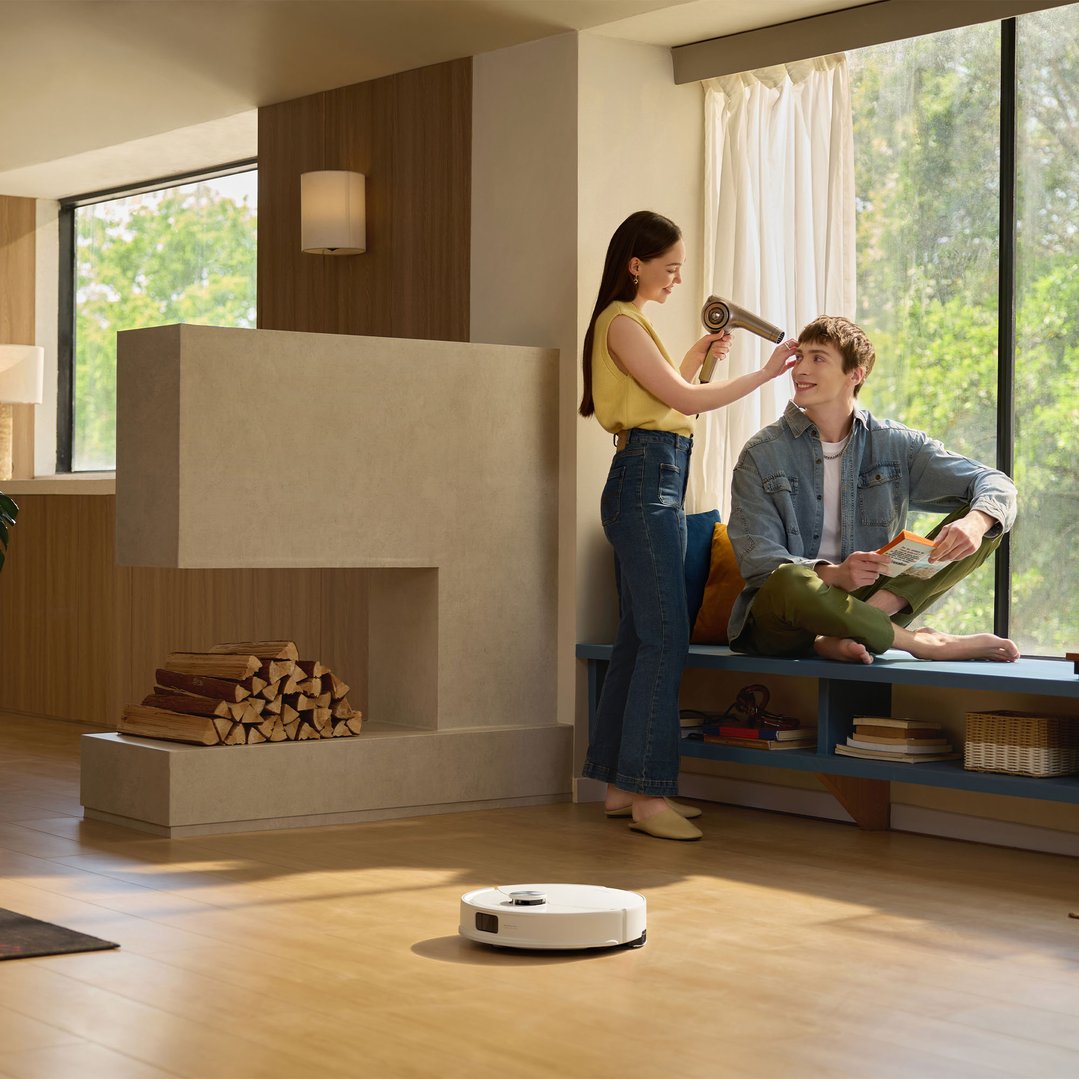 Robotic vacuum cleaner on a wooden floor in a living room scene