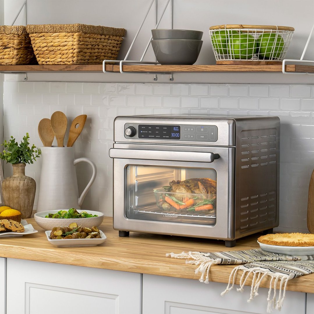Digital multifunctional air fryer oven on a kitchen counter with food
