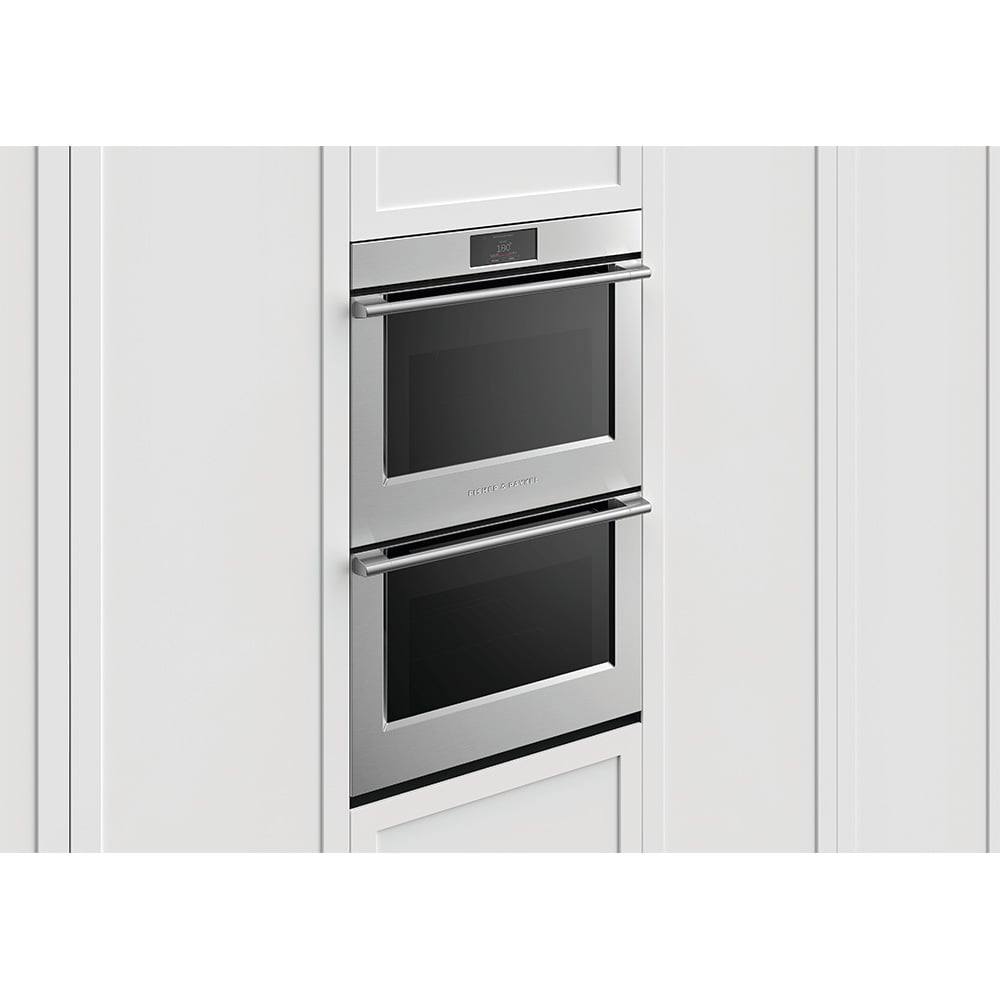 Stainless steel double oven built into white kitchen cabinetry