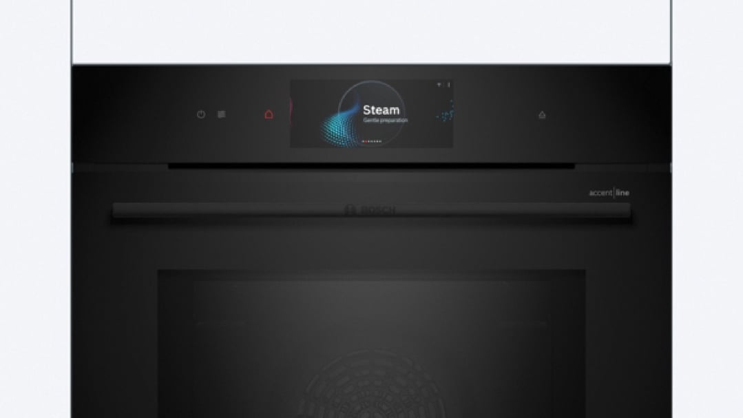 Black built-in oven with microwave and steam function in a kitchen setting