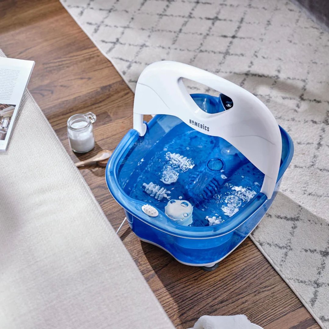 HOMEDICS footbath with heat boost on a wooden floor next to a rug