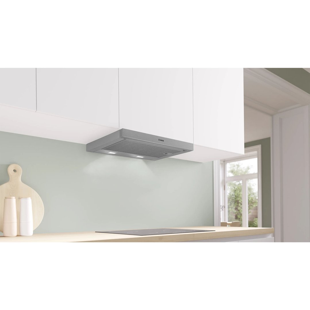 Silver metallic Bosch slideout rangehood installed above a cooktop in a modern kitchen