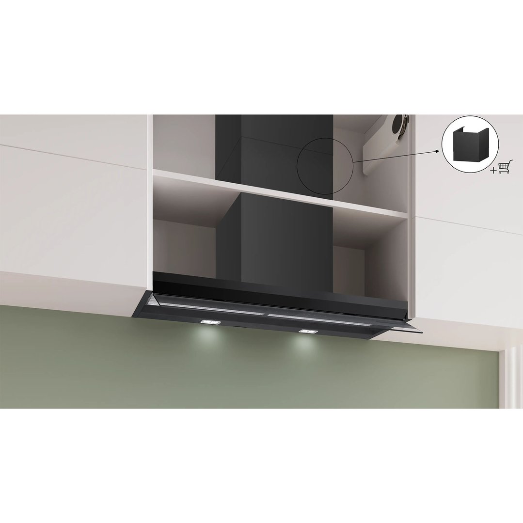 Black integrated rangehood installed in a white kitchen cabinet with lights on