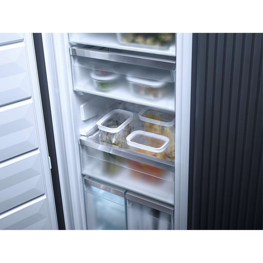 Open freezer showing various food containers on shelves and in drawers