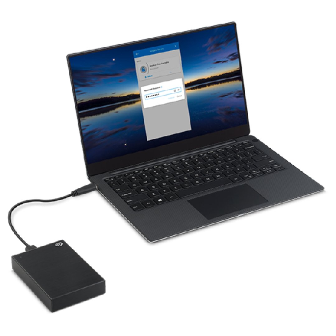Black external hard drive connected to a laptop displaying a security screen