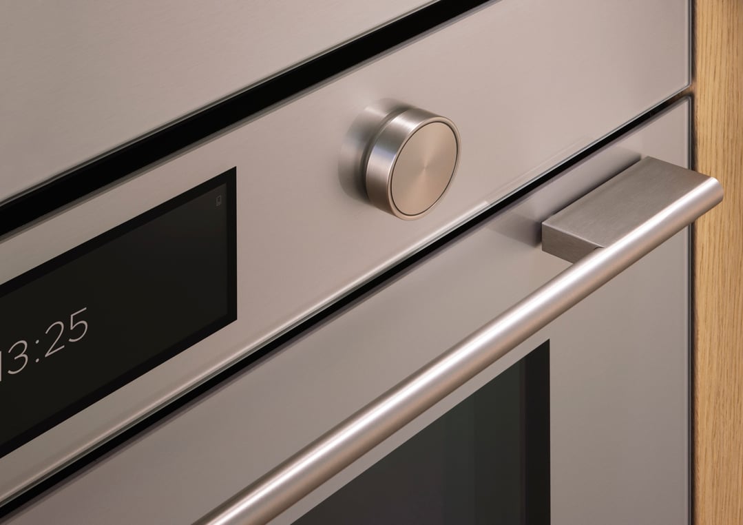 Close-up of a built-in oven with a digital display and control knob