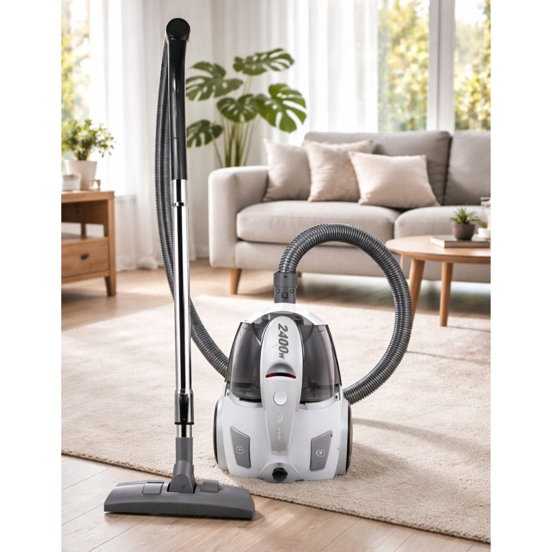 Bagless vacuum cleaner with hose and wand in a living room setting