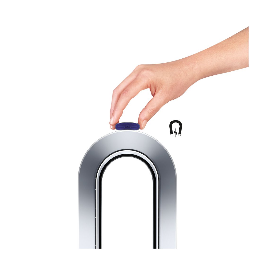 Hand placing a blue remote control on top of a Dyson air purifier