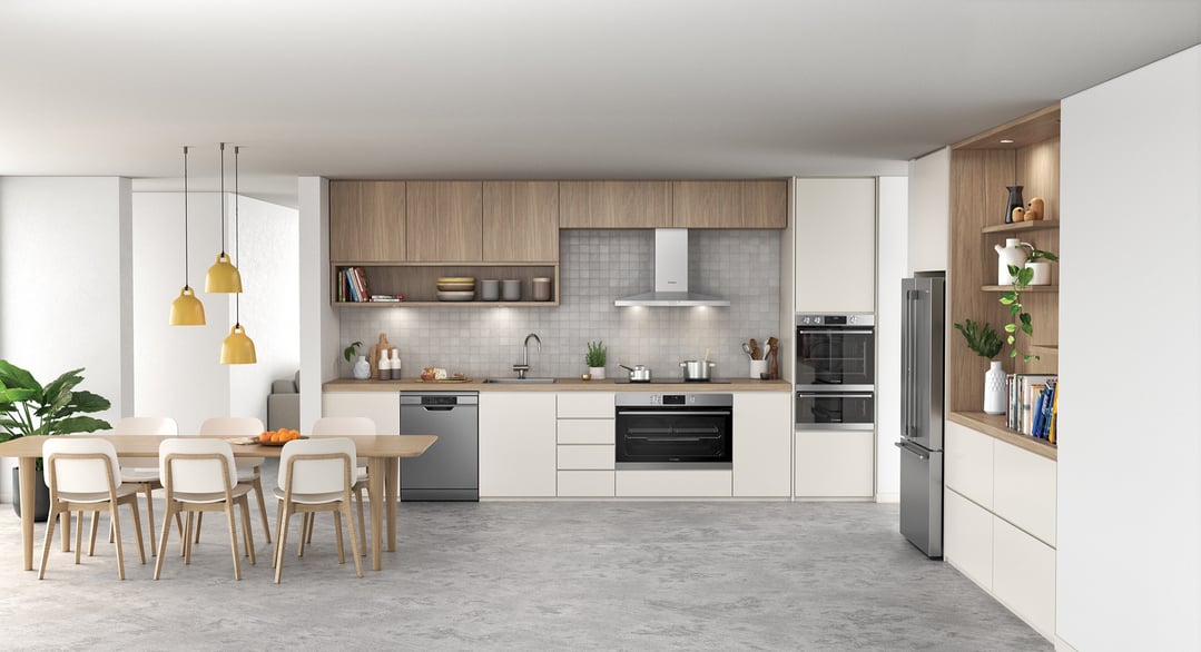 A modern kitchen and dining area with a stainless steel rangehood and appliances