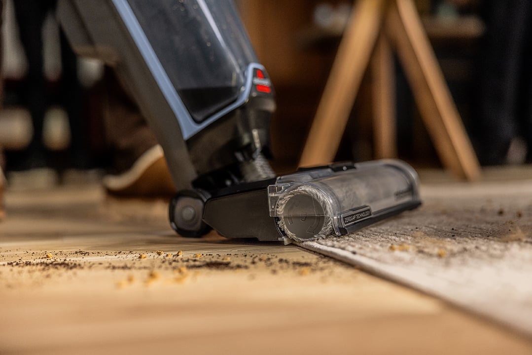 BISSELL CrossWave Edge Cordless vacuum cleaning dirt and debris from a rug