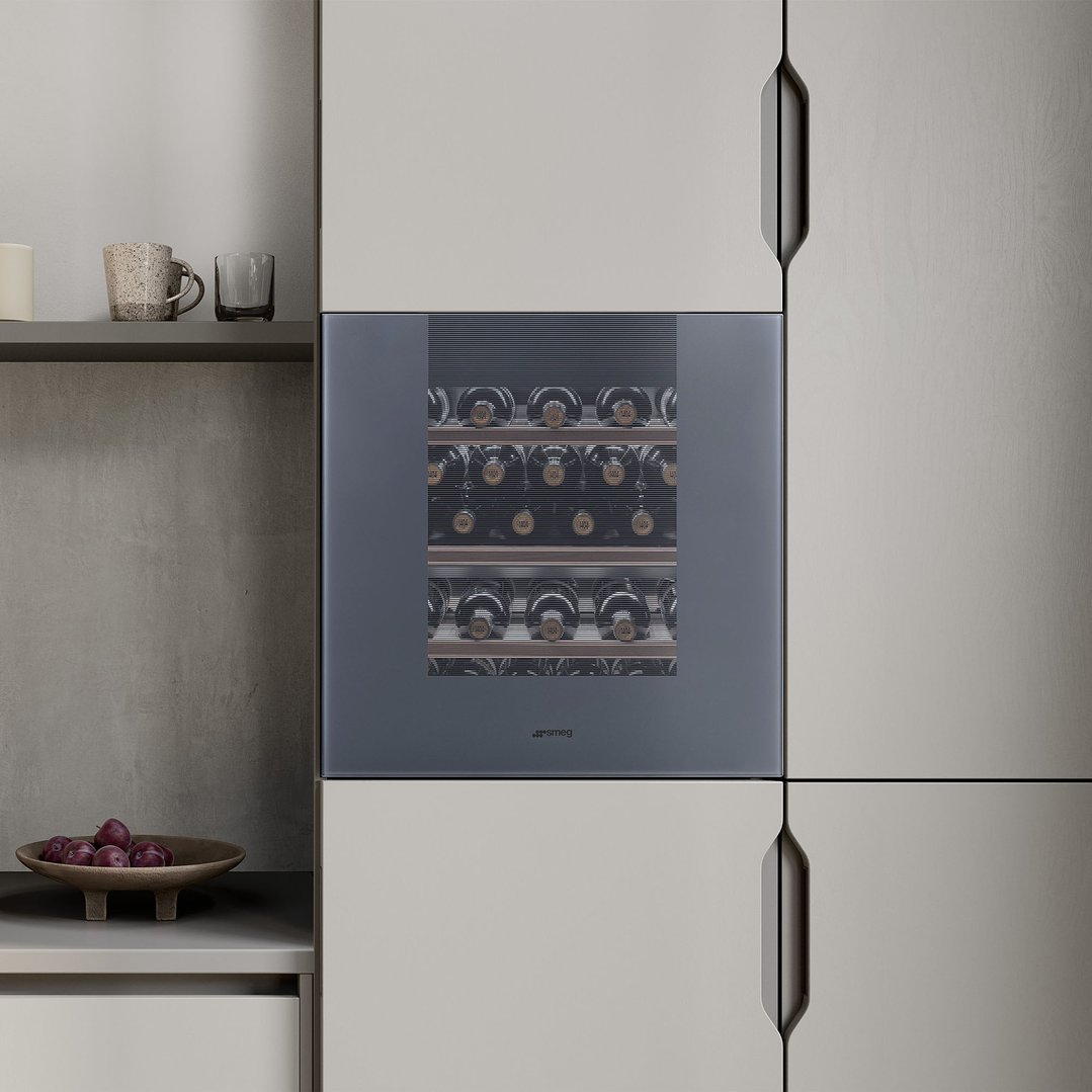 Built-in wine cellar in a modern kitchen with plums and mugs on a shelf