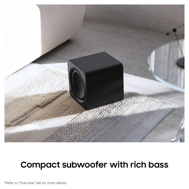 Black subwoofer on a textured rug in a living room setting