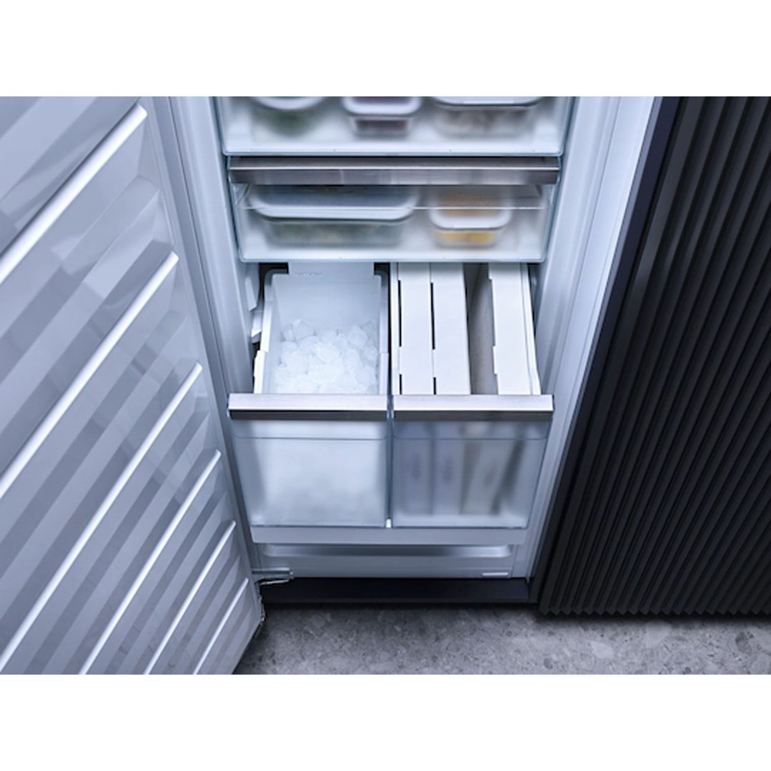 Open freezer interior showing ice maker and storage drawers