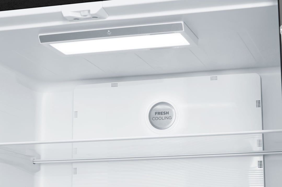 Interior view of a fridge with a light and "Fresh Cooling" feature