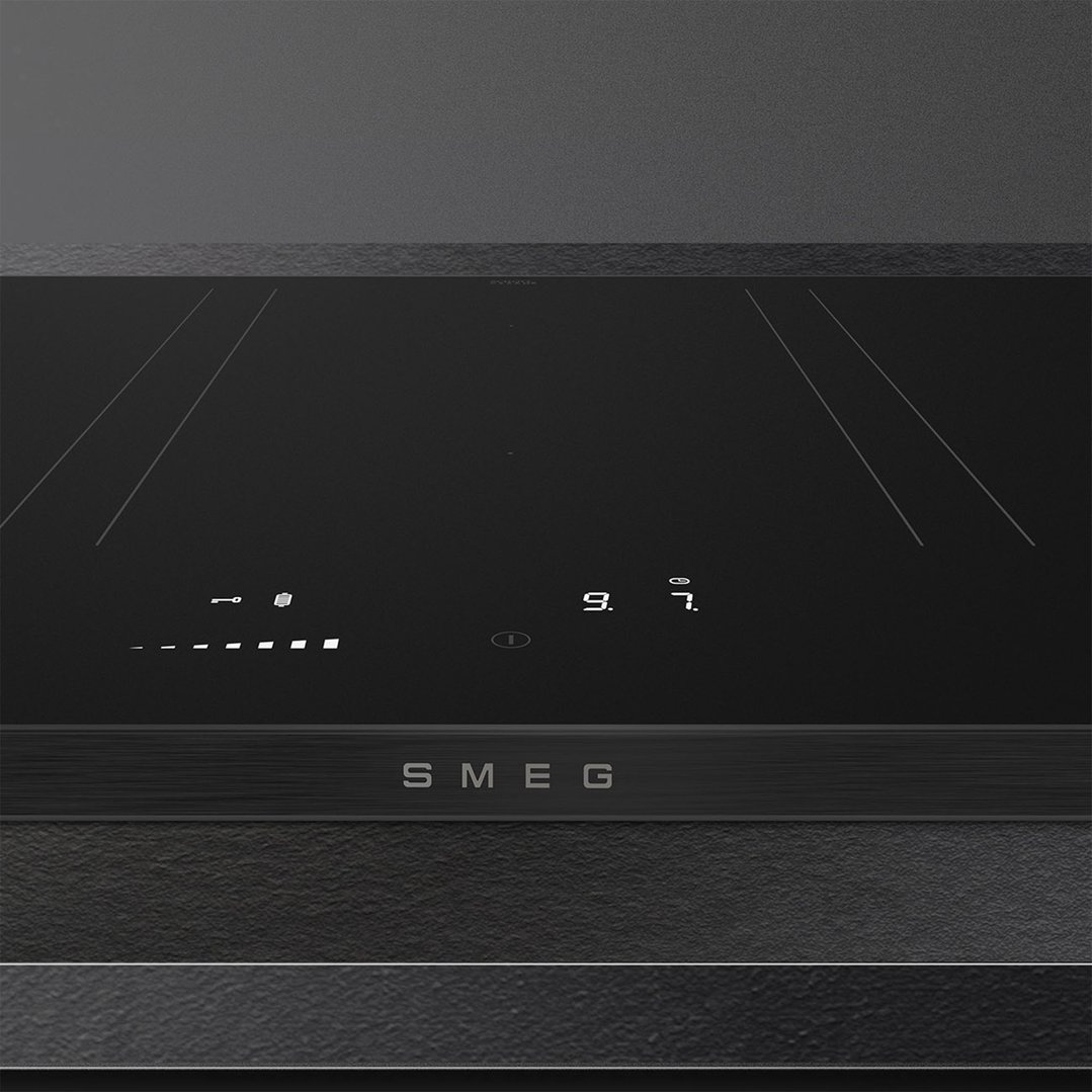 Close up of a black induction cooktop with digital controls