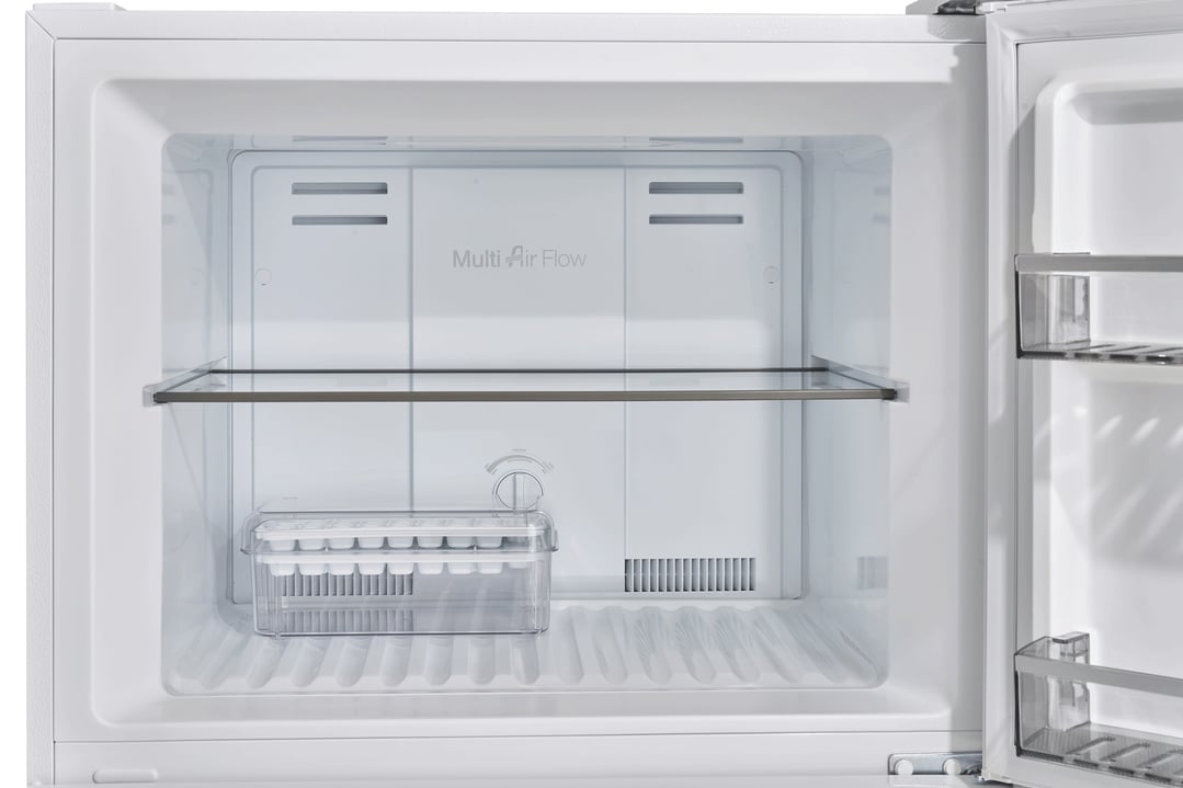 Interior view of a white top mount fridge with a glass shelf and ice tray