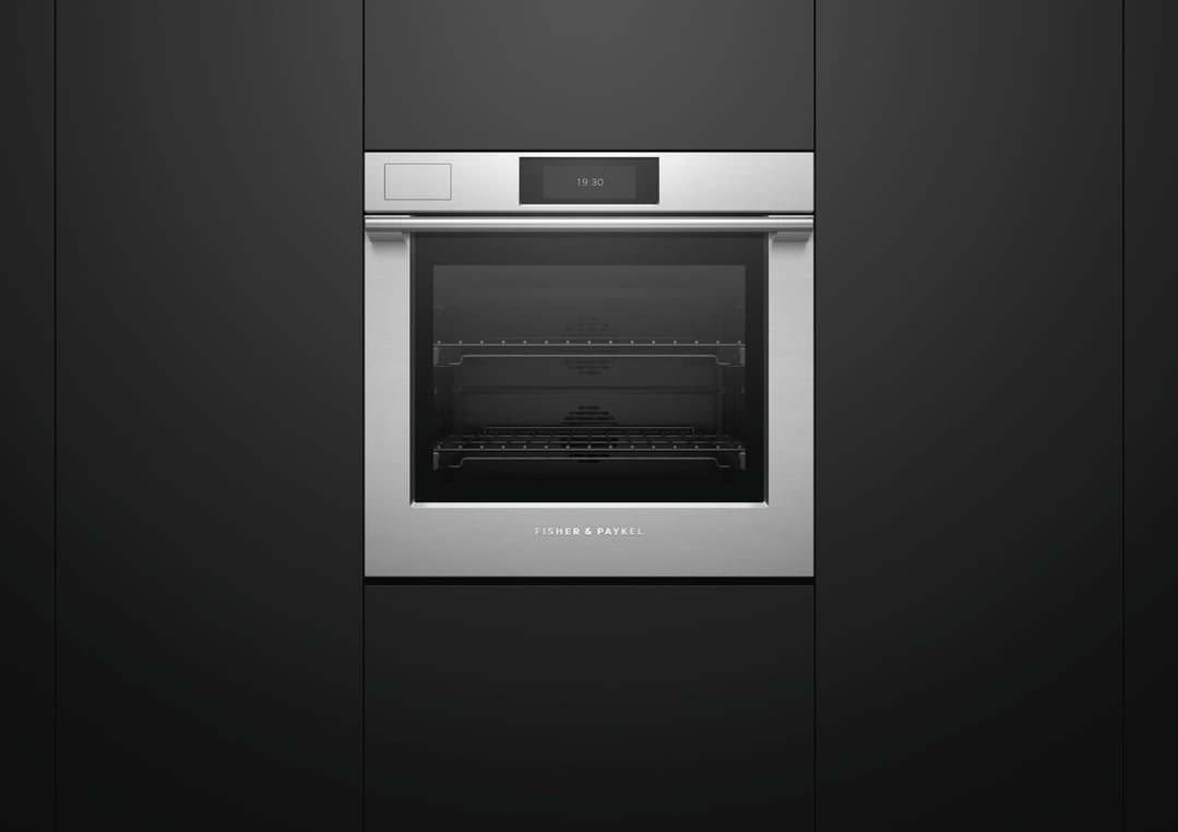 Stainless steel Fisher & Paykel oven built into dark cabinetry, displaying 19:30