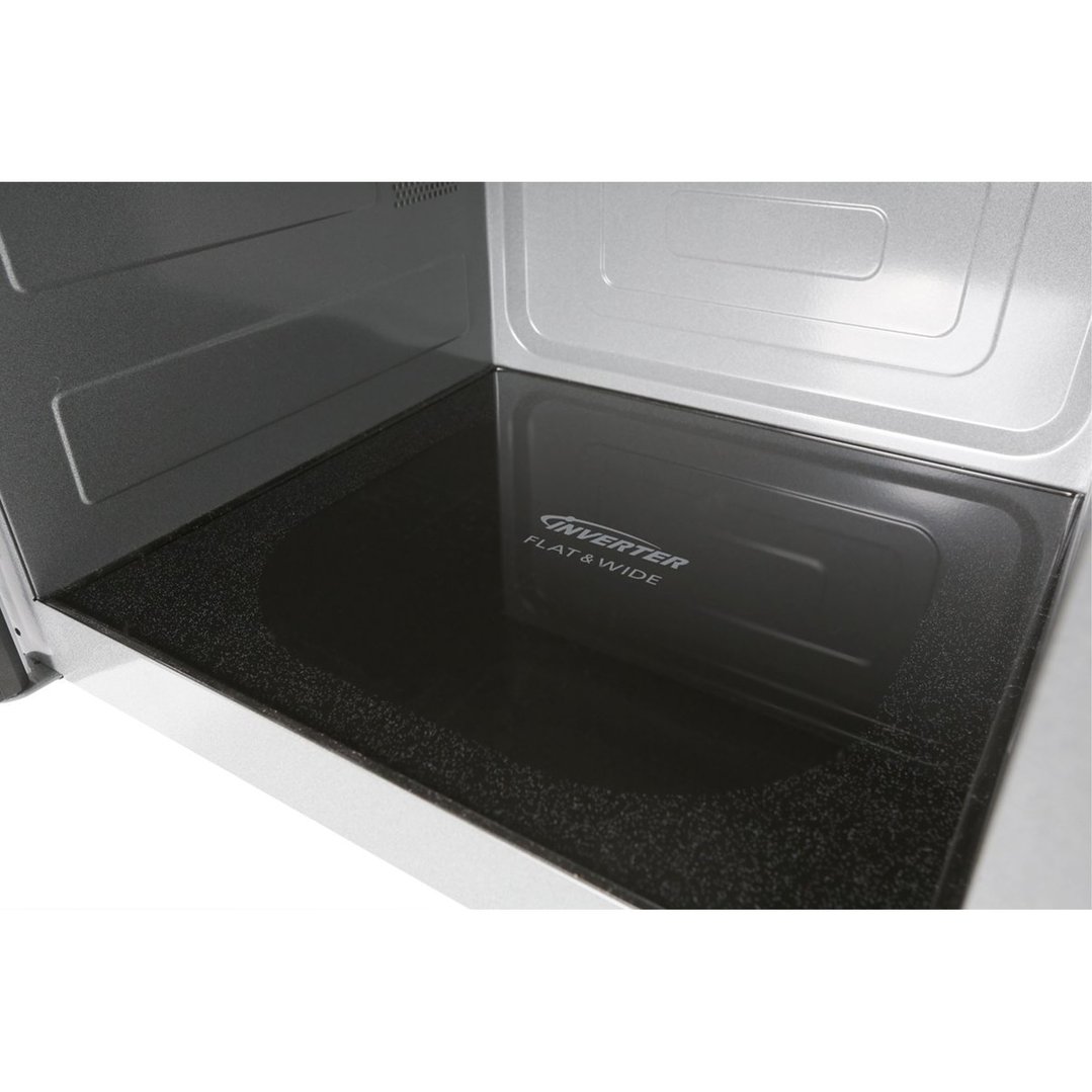 Close up of the interior of a microwave oven with a flat and wide base