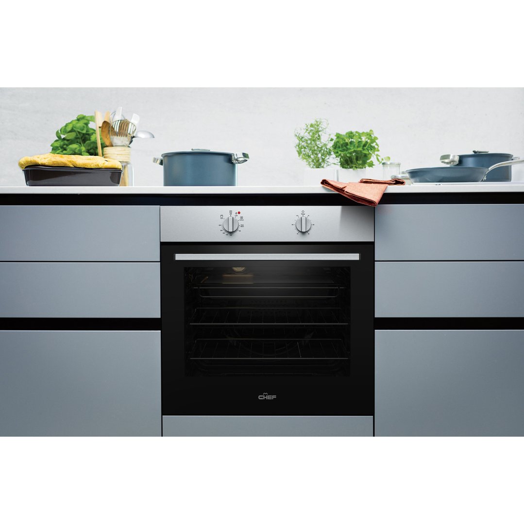 Built-in oven in a kitchen setting with cooking utensils and pots
