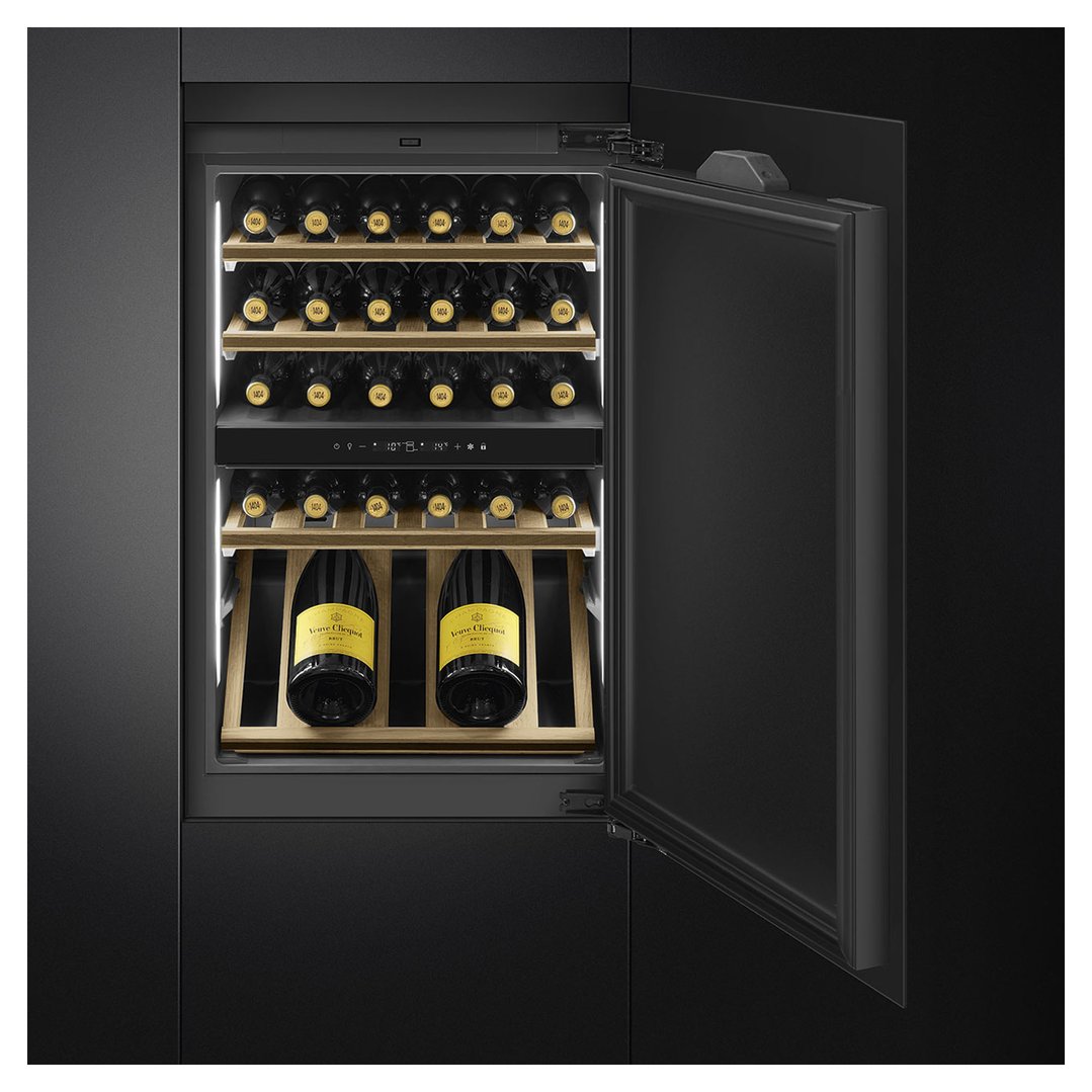 Built-in wine cooler with open door showing wine bottles on wooden shelves