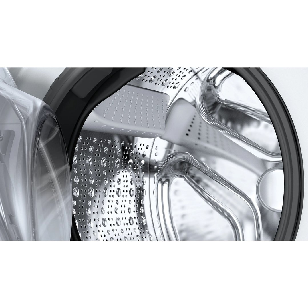 Close-up of the interior drum of a washing machine with water droplets