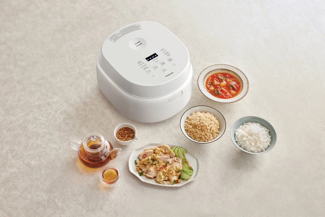 Panasonic Premium Rice & Multi Cooker with cooked food and tea on a counter
