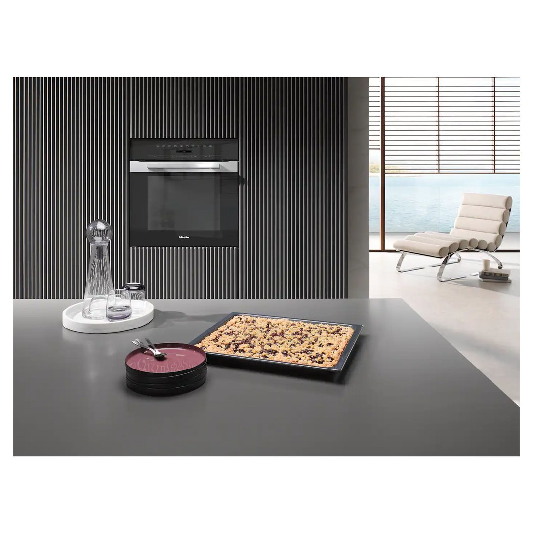 Built-in oven in a modern kitchen with a cake on the counter
