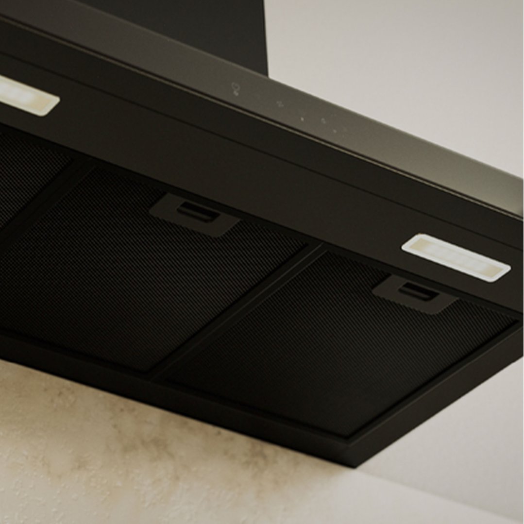 Close-up of a black rangehood with lights and controls in a kitchen