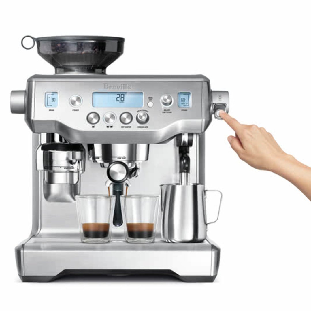 Hand pressing button on Breville Oracle Manual Espresso Coffee Machine