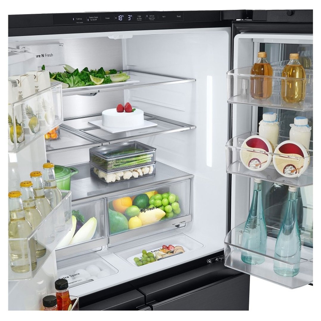 Open LG French door fridge interior filled with food and drinks