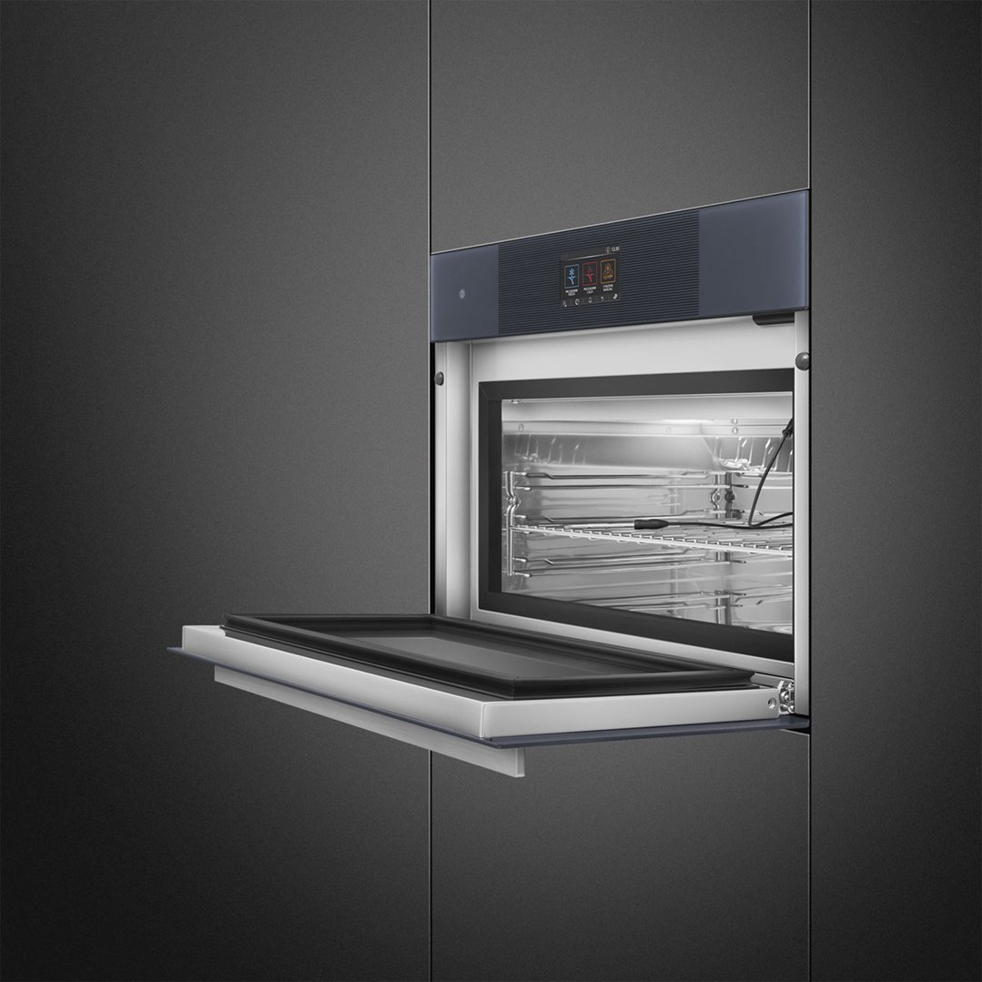 Built-in compact blast chiller with door open, showing interior racks and controls