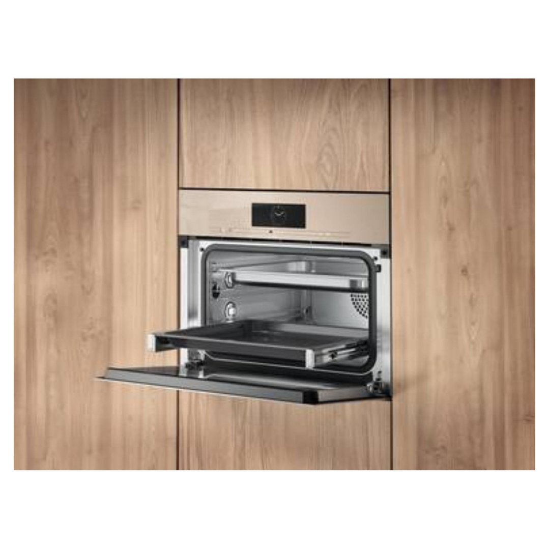 Pearl beige combination steam oven with door open, built into wooden cabinetry