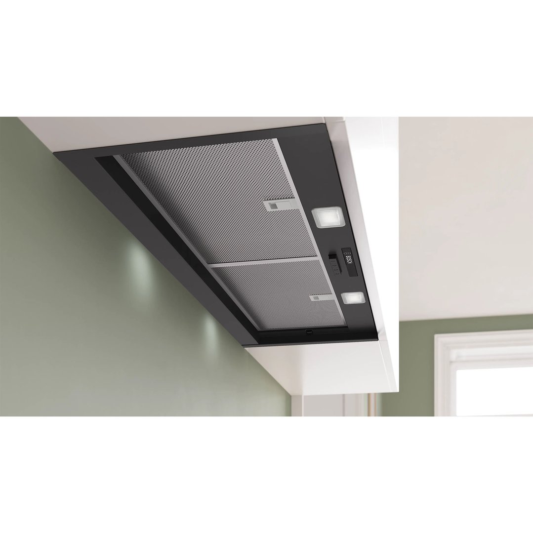 Integrated rangehood with mesh filters and lights installed in a modern kitchen