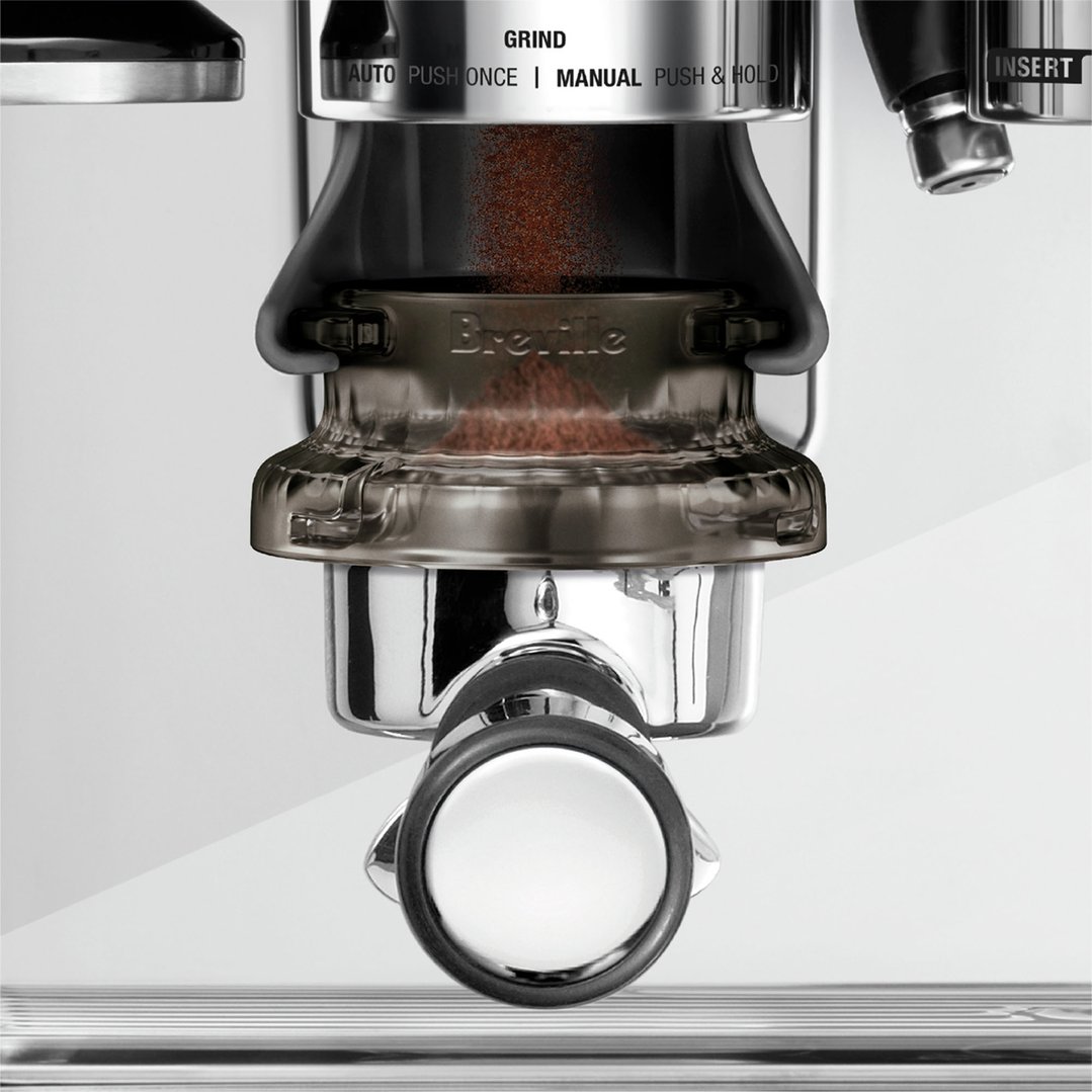 Coffee grounds falling into a portafilter from a coffee grinder
