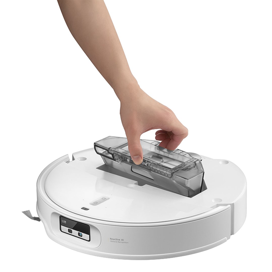 Hand removing the dustbin from the top of the white robotic vacuum