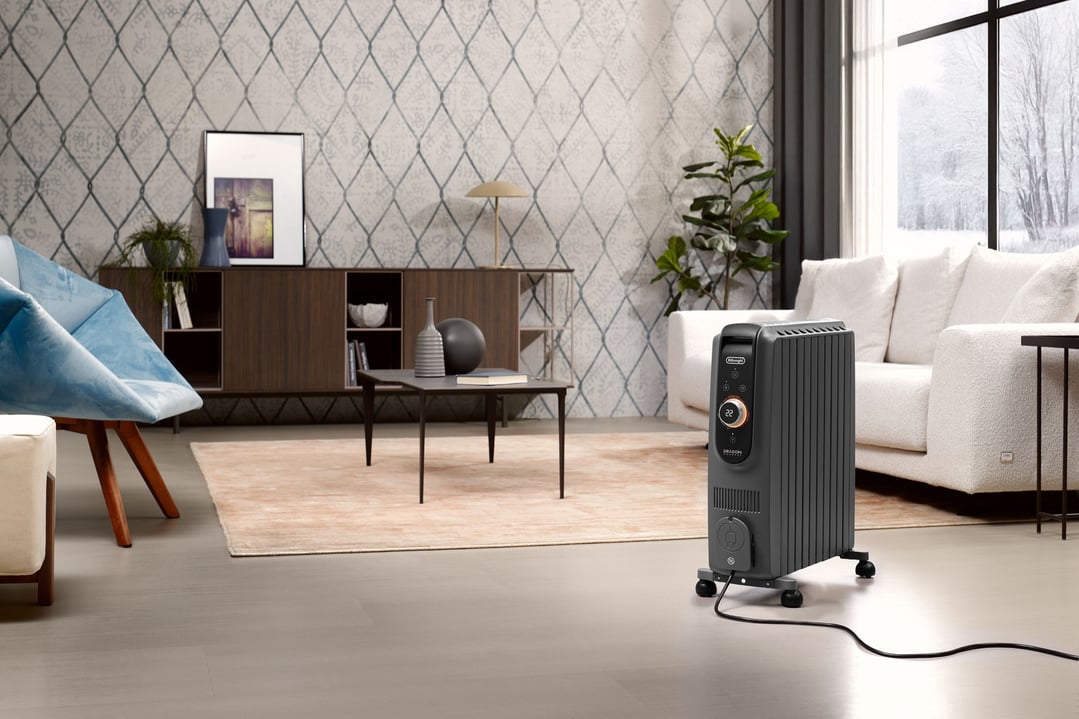 Oil column heater in a modern living room with a sofa and armchair