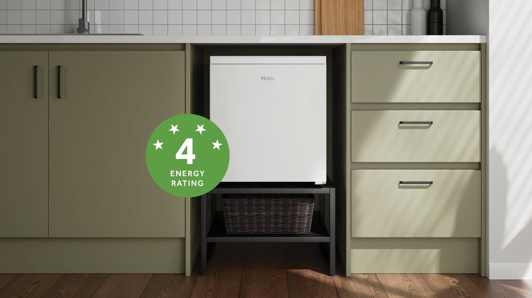 Haier bar refrigerator built into kitchen cabinetry with an energy rating label