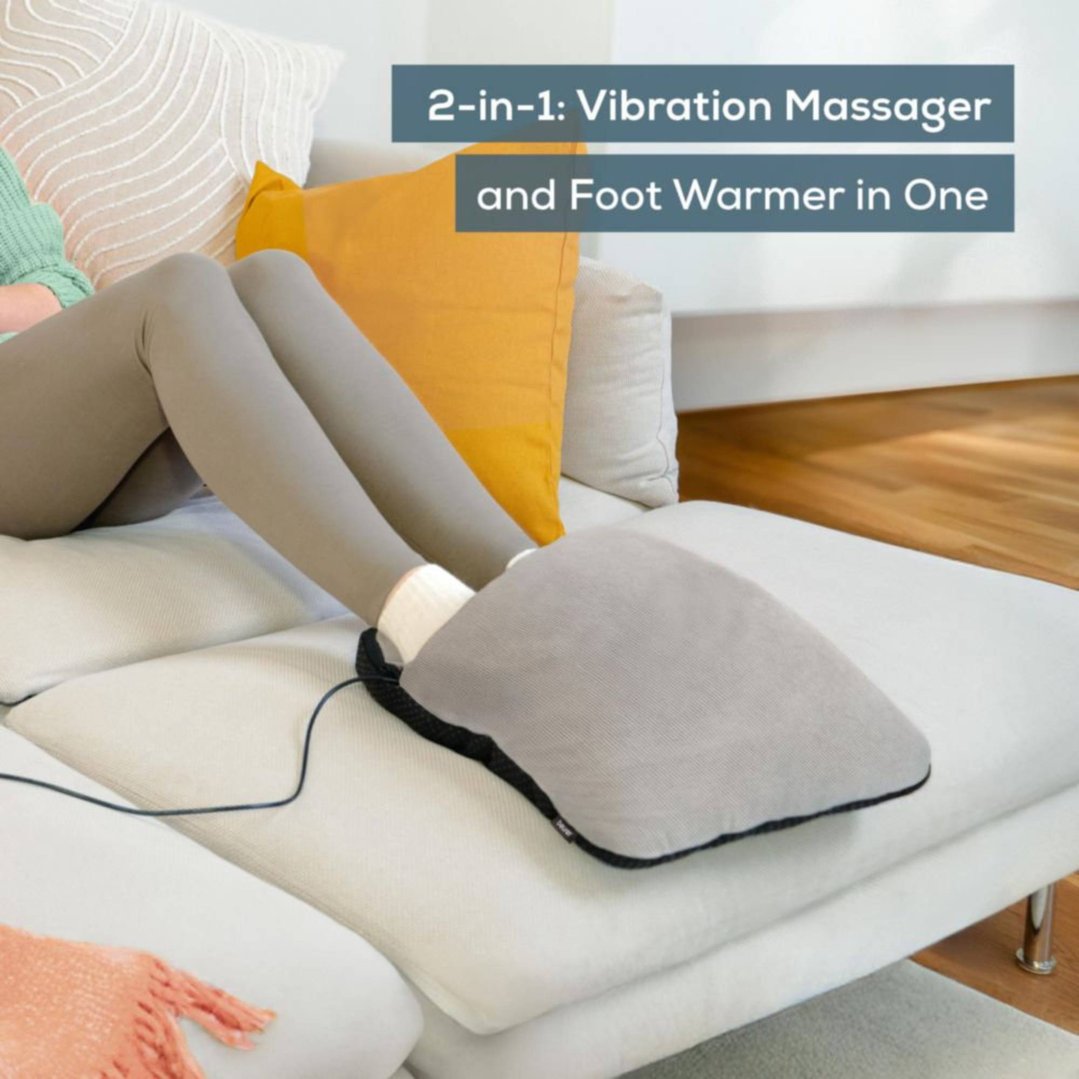 Woman using a foot massage cushion with heat on a sofa in a living room