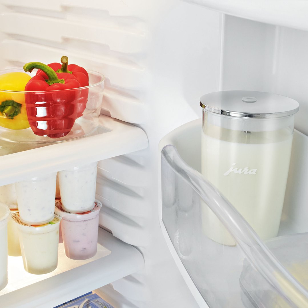 JURA glass milk container and other food items inside a refrigerator