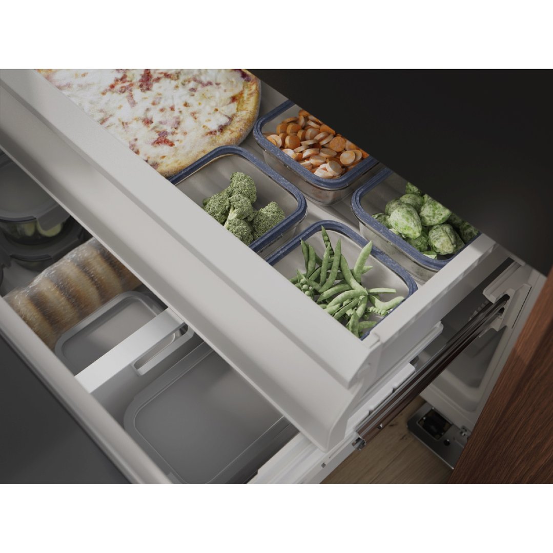 Open freezer drawer of a French door fridge filled with frozen food items