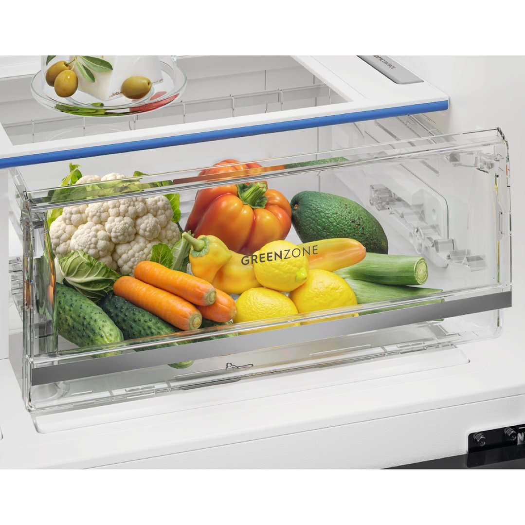 Close up of the fridge's GreenZone crisper drawer filled with fresh vegetables