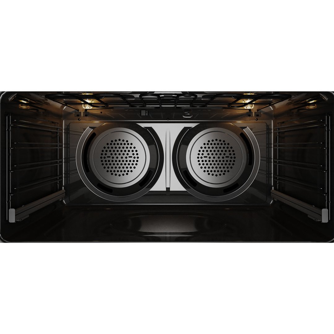Interior view of a dark stainless steel freestanding oven with lights on