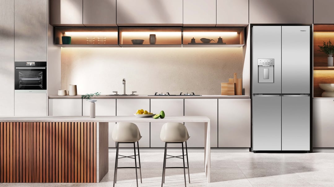 Stainless steel French door fridge in a modern kitchen with an oven and island
