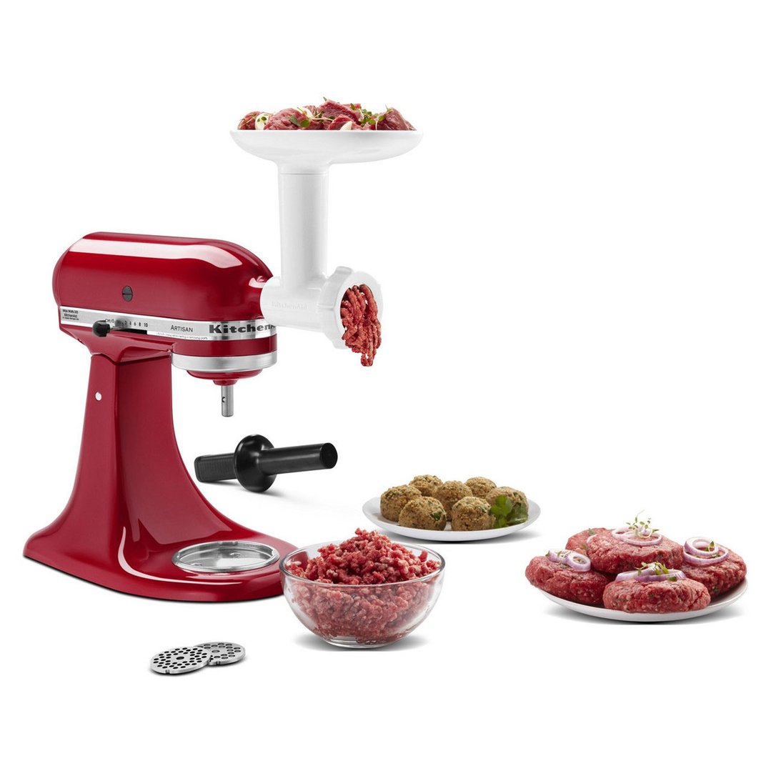 Red stand mixer with food grinder attachment processing meat, with prepared food