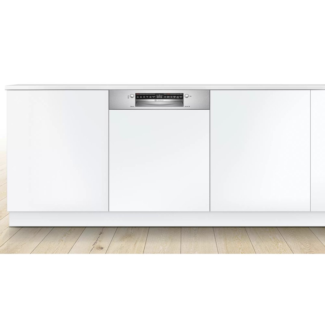 Semi-integrated dishwasher built into white kitchen cabinetry with wooden floor