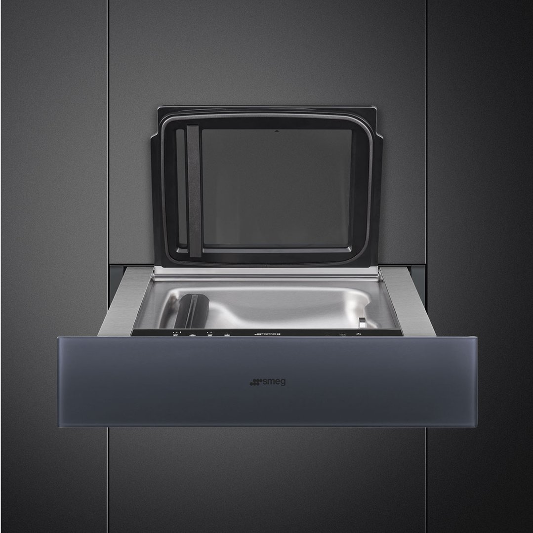 A Linea 15cm Vacuum Drawer in Neptune Grey, open in a dark kitchen