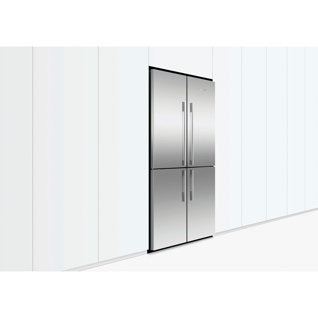 Stainless steel quad door refrigerator freezer built into white kitchen cabinetry