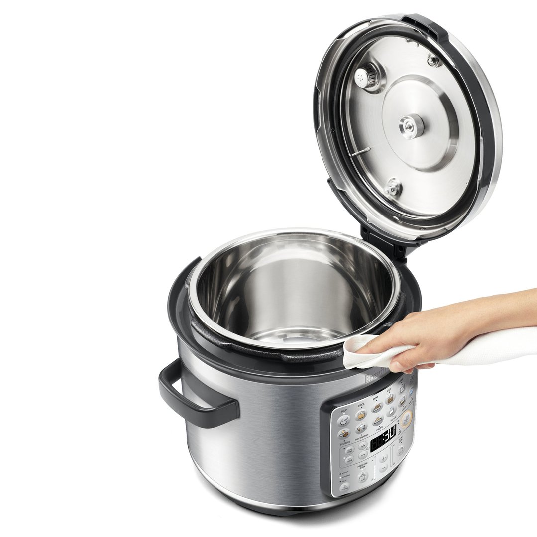 Hand wiping the rim of a Breville Fast Slow GO™ Pressure Cooker