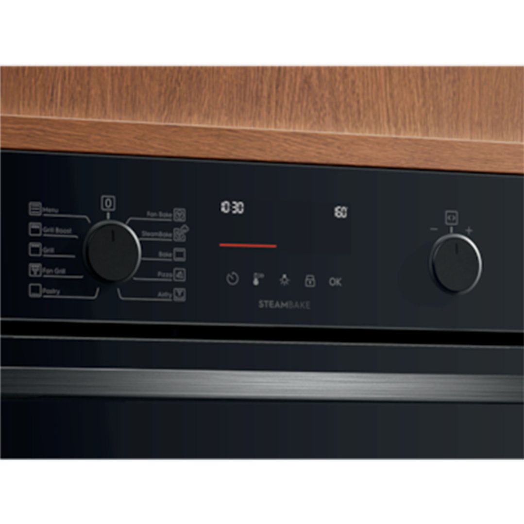 Close up of an oven control panel with dials and digital display